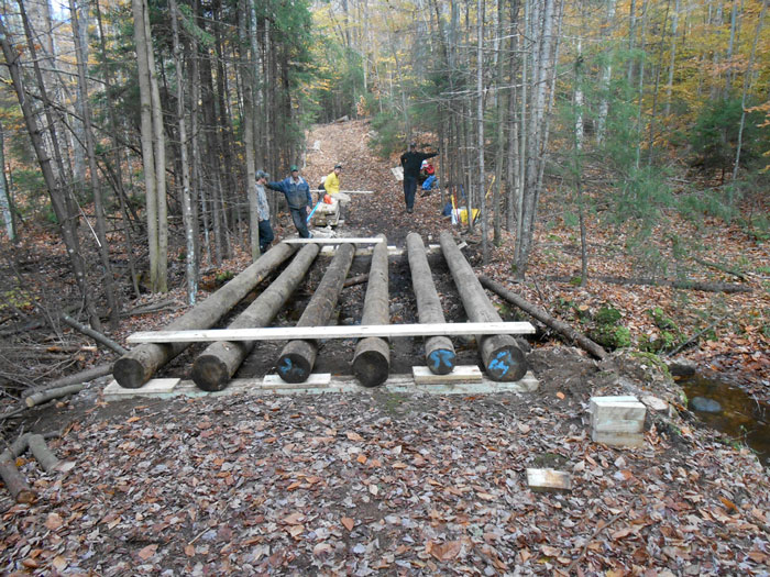 The APA should fully investigate and research the many different kinds of bridges used on the Forest Preserve when it considers changing the State Land Master Plan requirement that bridges be made of natural materials. Above is a snowmobile bridge under construction in the Moose River Plains.