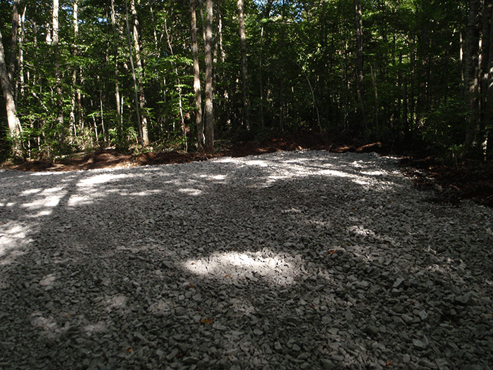 A close-up of a large gravel pull-off alongside the Bear Creek Road in the Black River Wild Forest.