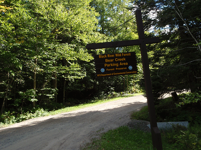 Public parking area at the end of the Bear Creek Road where it ends as a Town of Forestport Road and starts as a Forest Preserve Road. The Bear Creek Road is used by people who have private inholdings in the Forest Preserve. Many access their properties by ATVs. Use of ATVs by private inholders has encouraged widespread ATV trespassing in this general area.