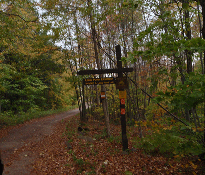 The Long Pond Conservation Easement is accessed from County Route 56. The access road passes through other commercial timberlands. The sign above marks the boundary of the Long Pond Conservation Easement.