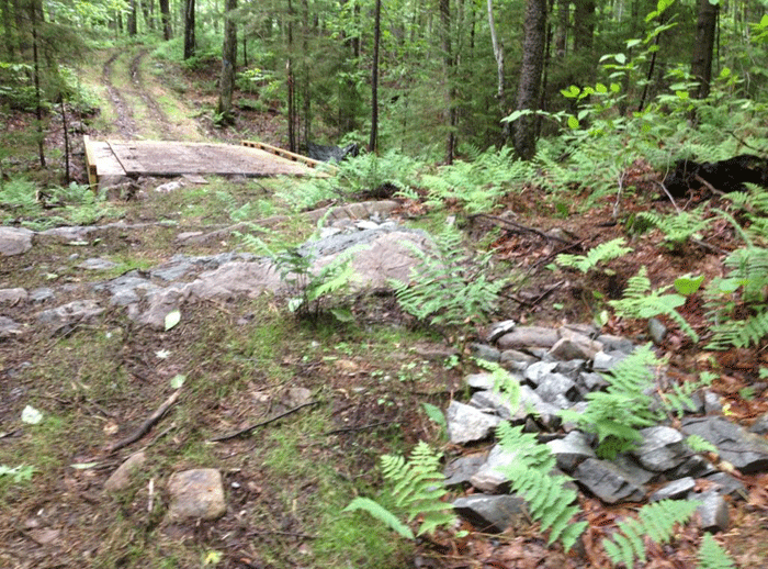 Bedrock is chipped away during trail construction of the Gilmantown Class II Community Connector Snowmobile Trail in the Jessup River Wild Forest area. This type of land alteration does not happen with other types of recreational trails on the Forest Preserve.