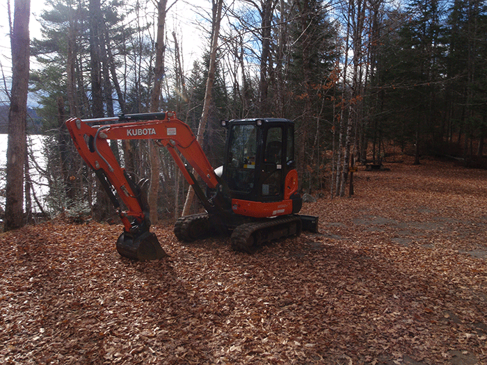 The heavy machinery that the Department of Environmental Conservation uses to grade and flatten the new class II community connector snowmobile trail to Harris Lake. This machine is used to cut bench cuts into side hills, remove stumps and boulders from the trail, and build up the and compress the roadbed.